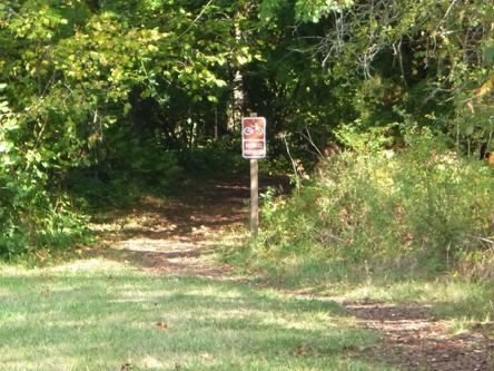 Natural surface trail goes through the woods &ndash; sign says bikes prohibited
