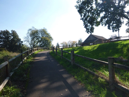 Paved trail with steep grade after passing the Manson Farmstead and barn