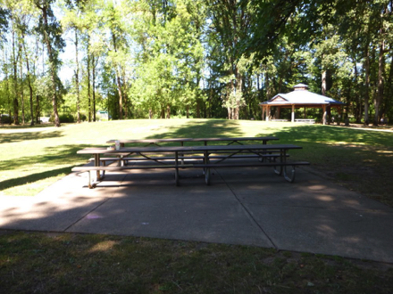 Two picnic tables on concrete slab &ndash; covered picnic area nearby