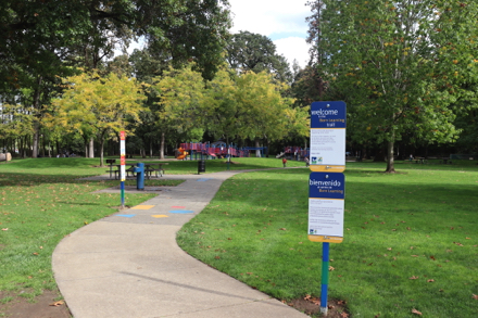 Signage about the paved Born Learning Trail from parking lot to playground &ndash; signs with activities and colorful illustrations