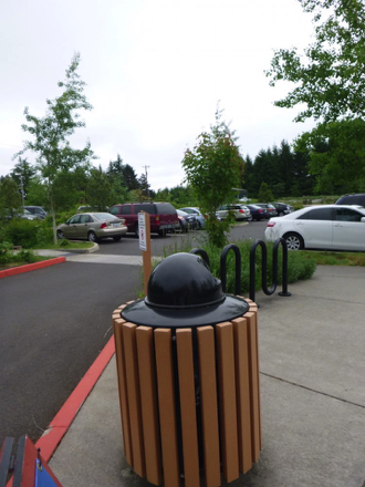 Parking lot has several accessible spaces &ndash; sidewalk has a bike rack, trashcan and interpretive signage