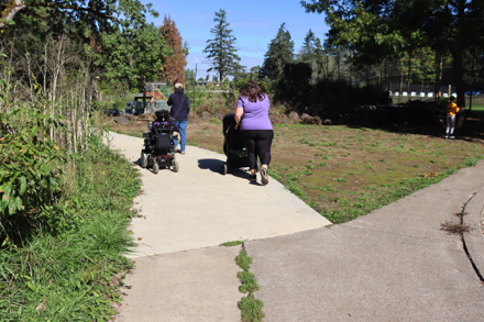 Paved trail to community garden, picnic shelter and historic house display