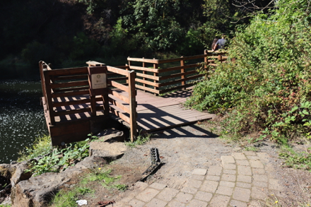 Paved trail transitions to pavers &ndash; transition to wooden deck may need maintenance