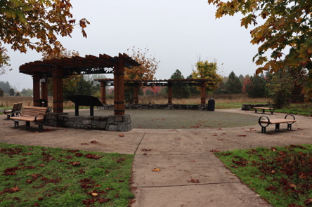Gateway Plaza on hard surface – short stone walls – benches, garbage can and informational display Gateway Plaza on hard surface – short stone walls – benches, garbage can and informational display