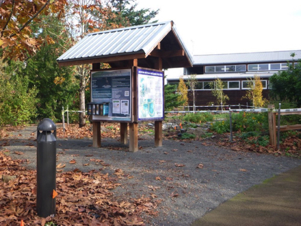 Information kiosk at main parking lot &ndash; paved surface with transition to compact gravel &ndash; possible lip