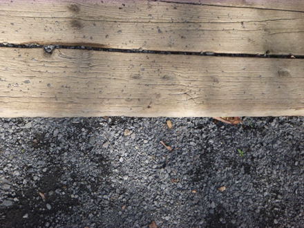 Transition from compacted gravel surface to wooden surface &ndash; may be a lip at transition