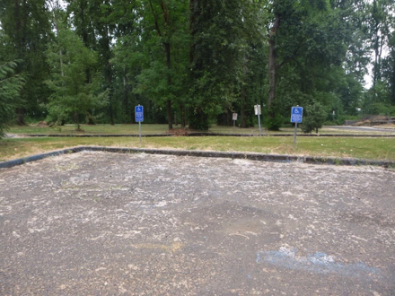 Furthest parking lot from the entrance - hard surface - accessible parking spaces - lot is not well maintained