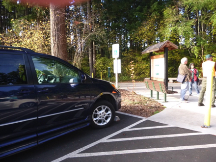 Accessible parking at main entrance with kiosk and benches