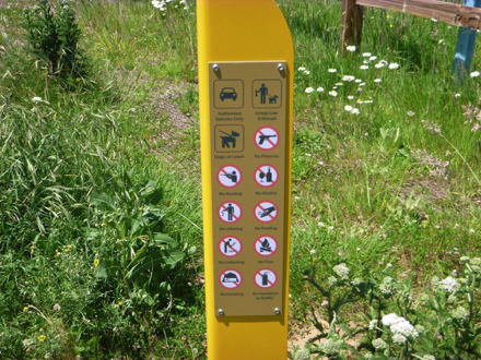 Sign post indicating park rules