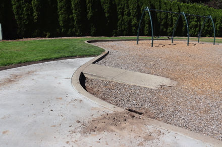 Playground on bark-chip surface with access ramp &ndash; paved access route from parking lot