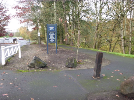 Hard surface sidewalk that parallels the driveway entrance &ndash; gate to close park &ndash; decorative rocks