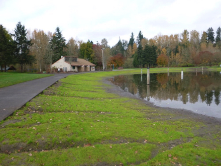 Hard surface path at pond &ndash; grass between path and pond &ndash; gravel &ndash; restroom &ndash; roped off for swimming in summer