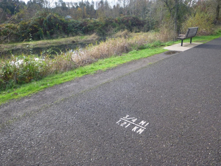 Example of distances marked on the Salmon Creek Greenway Trail &ndash; hard surface &ndash; bench &ndash; pond