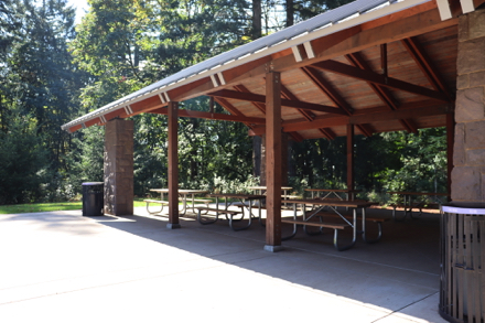 Covered picnic shelter with picnic tables inside and outside &ndash; accessible restroom