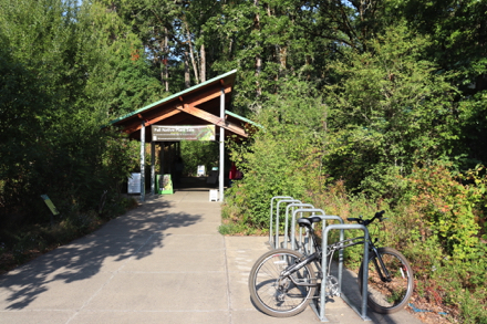 Bike rack at entrance leading to trailhead - Nature Center with restrooms on left &ndash; restrooms in building on right