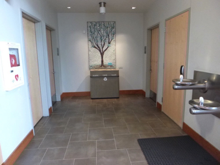 Hallway to restrooms at the Tualatin Library - two-tiered water fountains - garbage/recycling bin