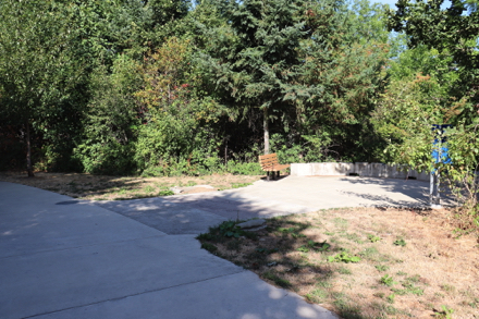 Hard surface trail - overlook at river - bench with arms - replica of tusks - engraved prehistoric fish