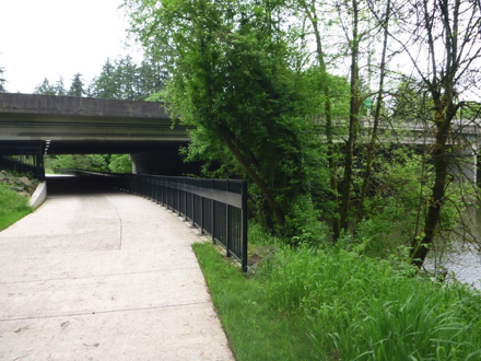 Hard surface trail under the Interstate 5 freeway - Tualatin River - iron fence  - security camera - lighting