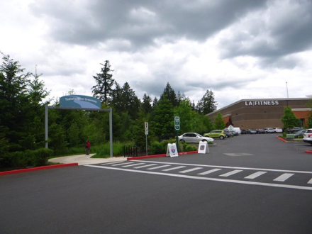 Trail entrance with crosswalk behind Cabela's store - entrance sign - bike rack