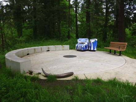 River overlook - hard surface trail - small wall - bench with arms - replica of tusks - informational display