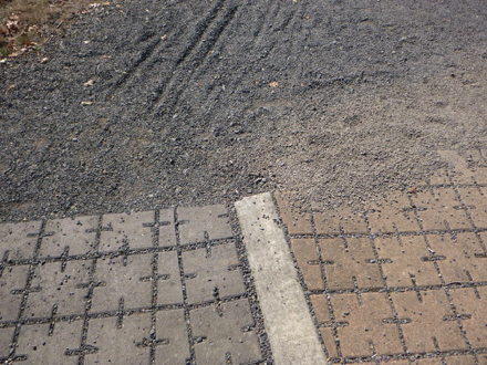 Concrete pavers from the main parking lot and Wildlife Center transition to the gravel trail to bus stop