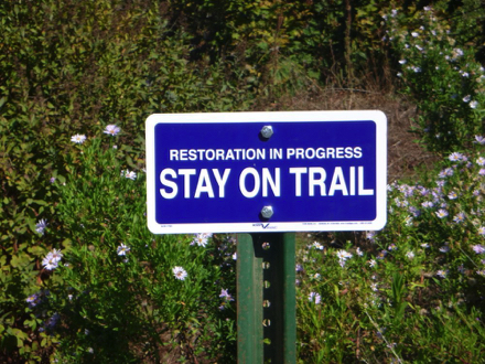 Sign says &ldquo;Restoration in progress, Stay On Trail&rdquo;